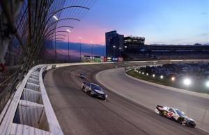NASCAR Sprint Cup Series drivers race into the night under the lights at Texas Motor Speedway in Fort Worth, Texas. [Credit: Jared C. Tilton/NASCAR via Getty Images]