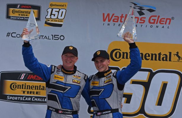 GT class victors Cameron Cassels and Trent Hindman hoist their winning hardware. [Joe Jennings Photo]
