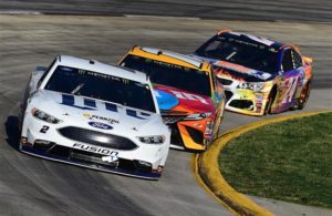 Brad Keselowski leads Kyle Busch and Chase Elliott during the Monster Energy NASCAR Cup Series STP 500 at Martinsville Speedway. [Photo by Jared C. Tilton/Getty Images]