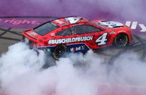 Kevin Harvick celebrates with a burnout after winning the NASCAR Cup Series FireKeepers Casino 400 at Michigan International Speedway. [Photo by Mike Mulholland/Getty Images]